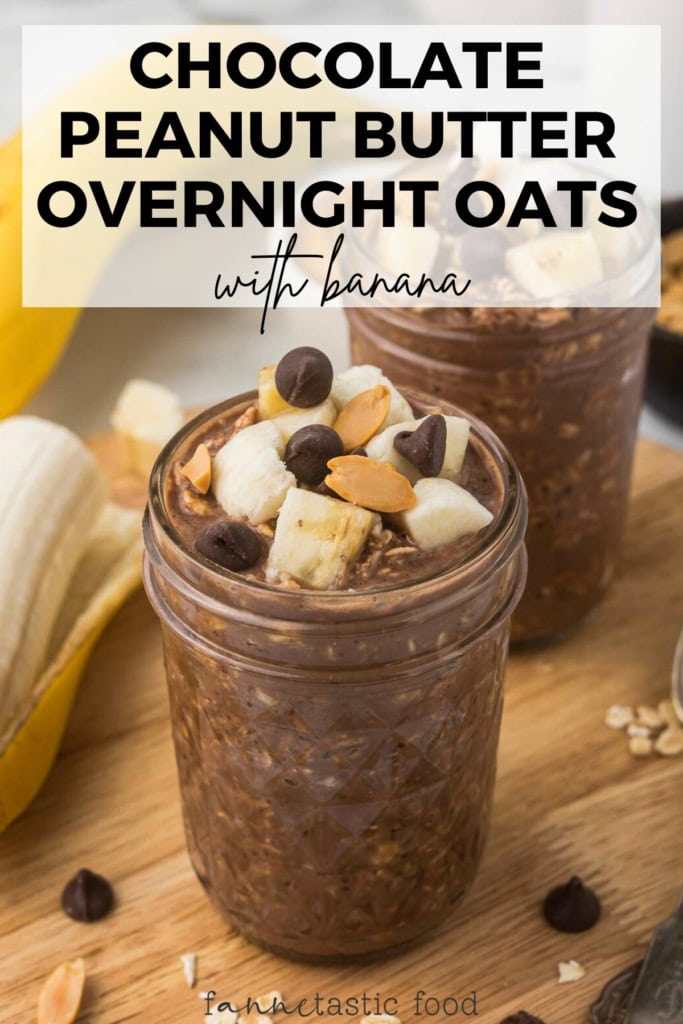 a mason jar with chocolate peanut butter overnight oatmeal topped with banana slices and chocolate chips on a wooden board