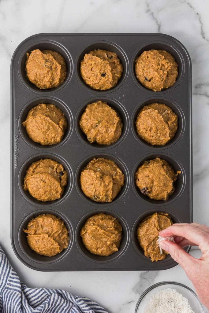 sweet potato muffin batter scooped into a muffin tin