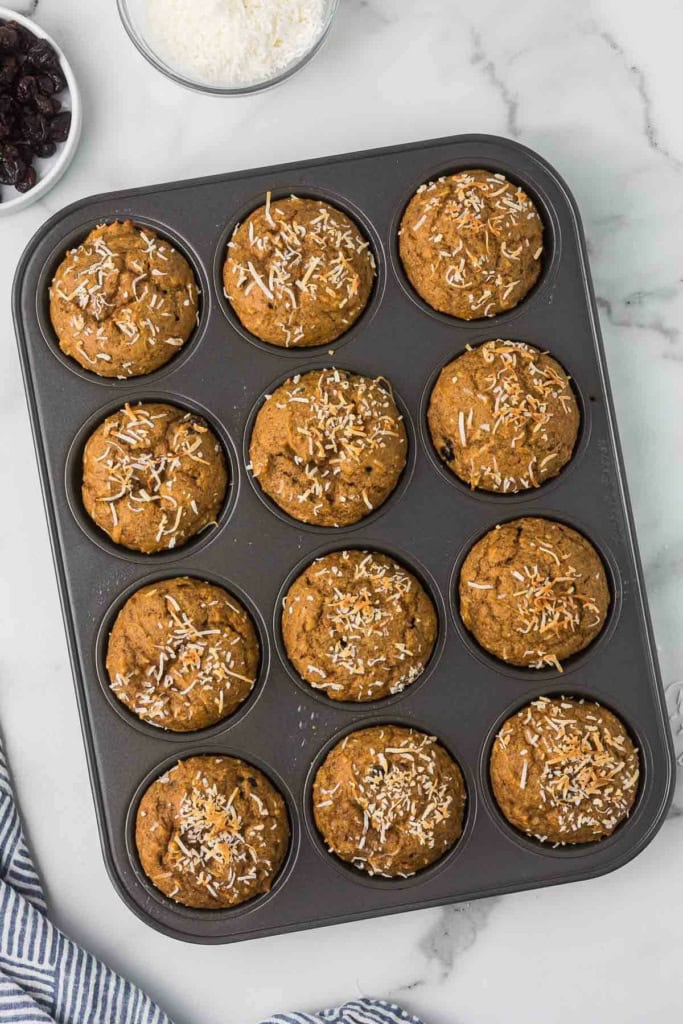 baked whole wheat sweet potato muffins with coconut in a muffin tin