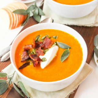 Instant Pot apple butternut squash soup in a bowl with bacon, sage, and Greek yogurt