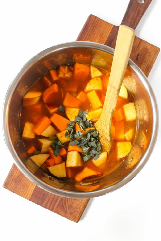 cubed butternut squash in an Instant Pot with vegetable broth