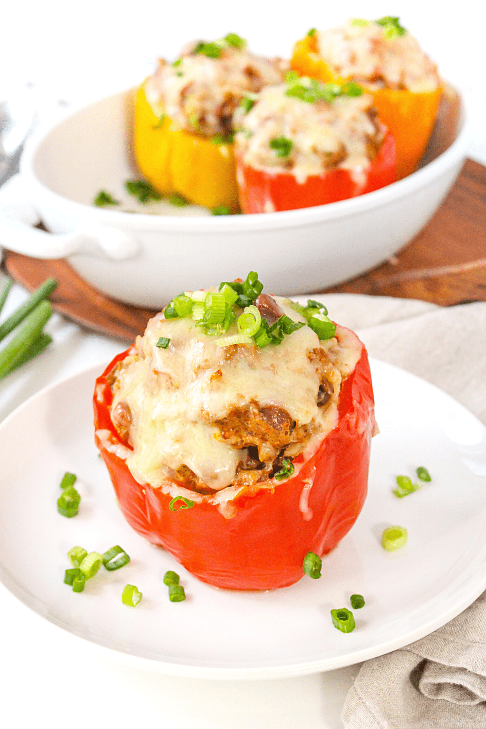 Instant Pot stuffed pepper with ground turkey and melted cheese on a white plate