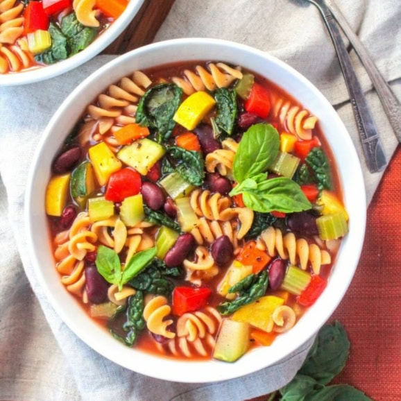 vegetable and pasta minestrone soup with kidney beans in a bowl