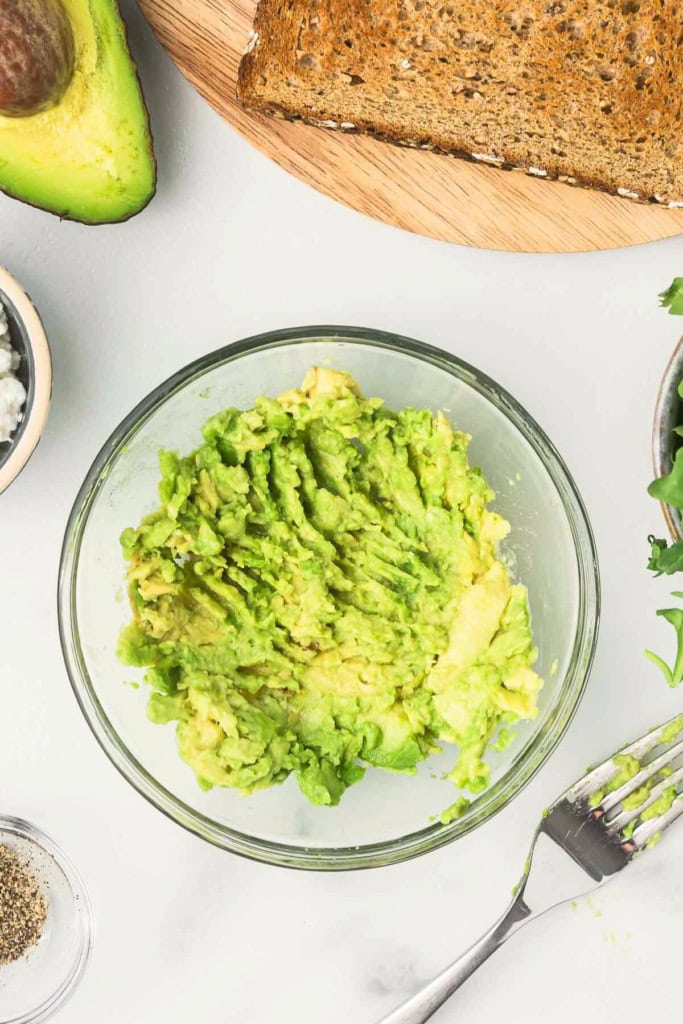 mashed avocado in a glass bowl