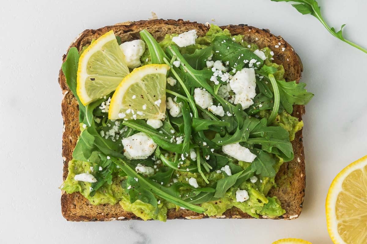 smashed avocado toast with goat cheese and lemon slices