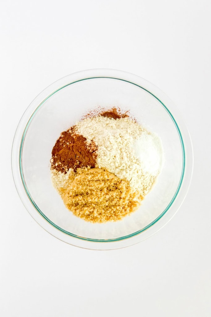 white whole wheat flour, brown sugar, cinnamon, and nutmeg in a glass bowl