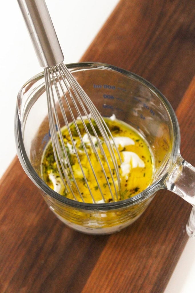 dressing ingredients in a glass measuring cup