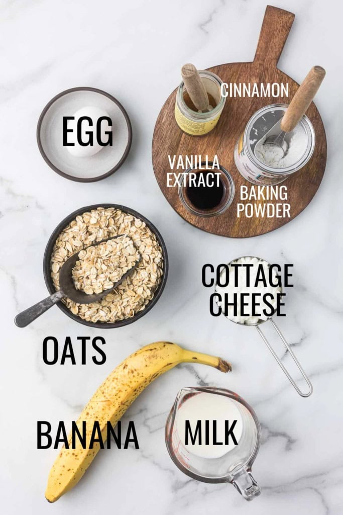 cottage cheese, oats, banana, milk, egg, baking powder, vanilla extract, and cinnamon in small glass bowls