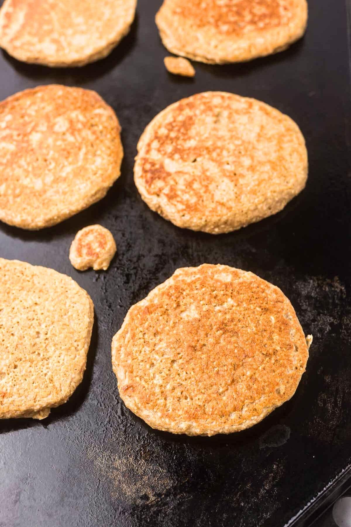 oat pancakes on a griddle