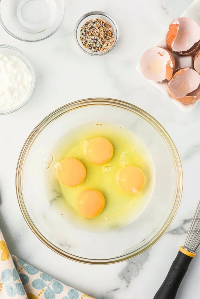 eggs cracked into a glass bowl