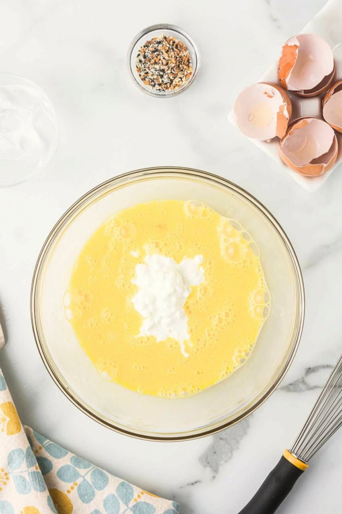 scrambled eggs with cottage cheese in a glass bowl