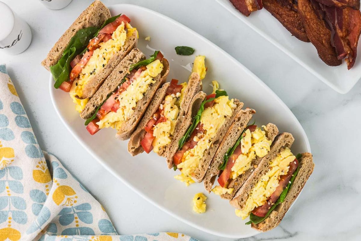 sliced scrambled egg sandwiches with cottage cheese on a platter