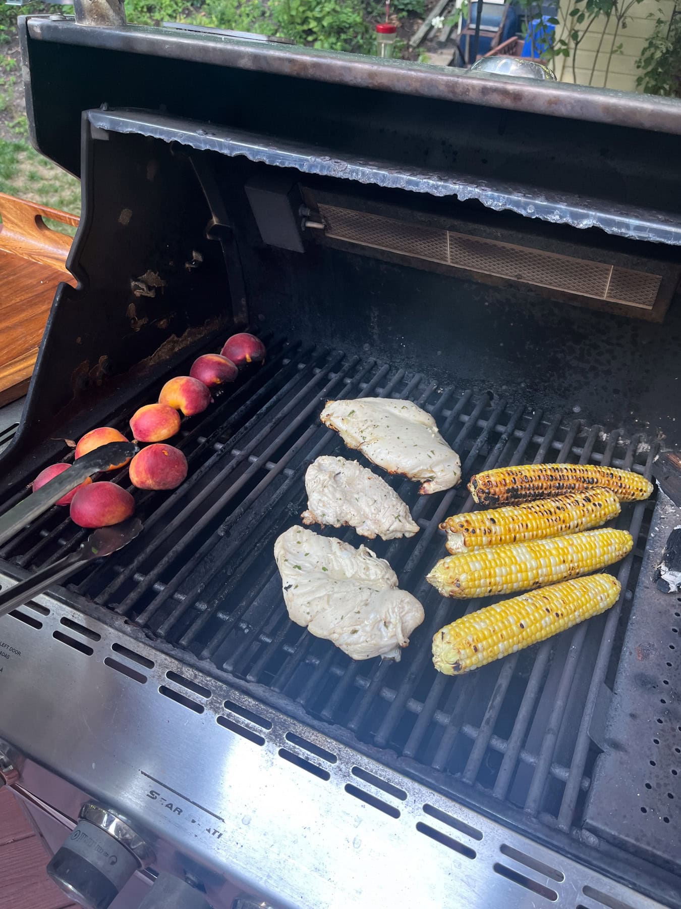 chicken, peaches, and corn on the grill