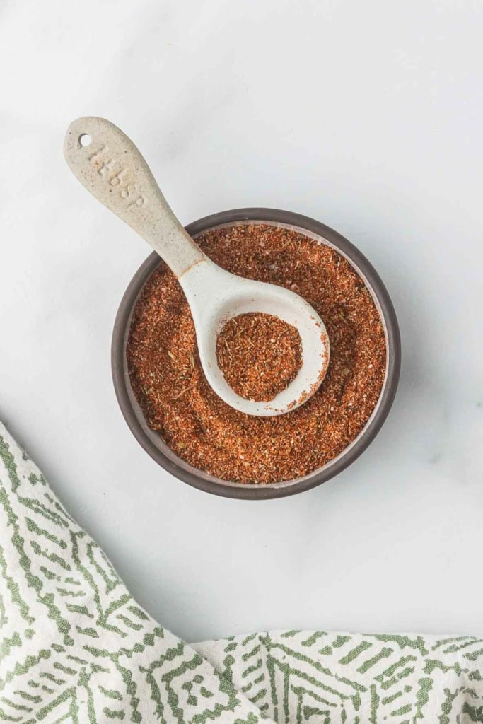 blackening seasoning in a small glass bowl with a spoon