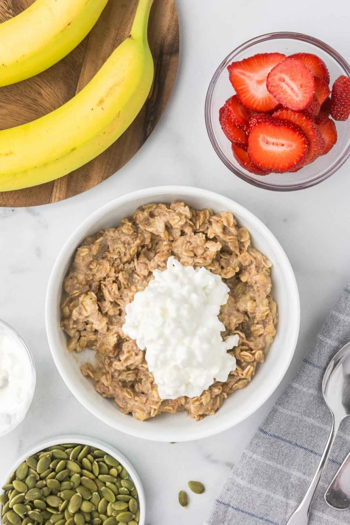 a bowl of oatmeal with cottage cheese on top